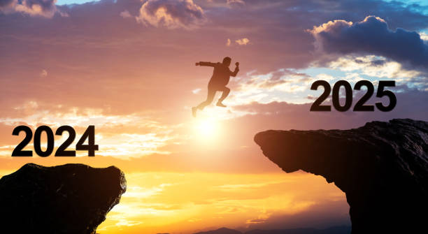 istock Single businessman jumping from 2024 cliff to 2025 2161094941