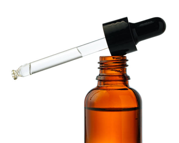 istock Dropper Bottle With Liquid Dropping on a White Background 2161097415