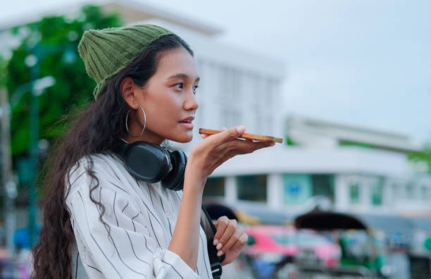 Asian woman using ai apps for calling taxi