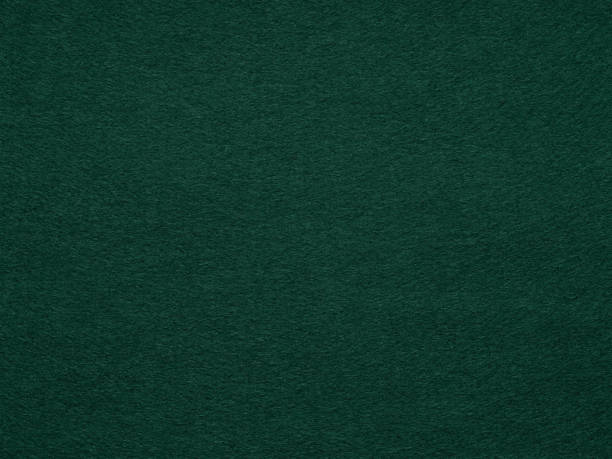 Dark green poker table felt soft rough textile material background. Dark green poker table felt soft rough textile material. Background texture close up with shade vignette. Soft pattern for text, lettering, patchworkor other art work. Full frame backdrop wallpaper. light green texture stock pictures, royalty-free photos & images