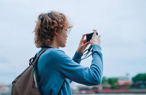 istock Asian young man traveling at riverside 2161097980
