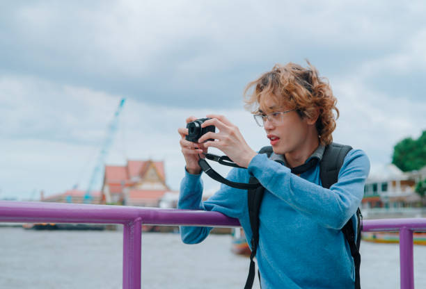 istock Asian young man traveling by ferry boat 2161098330