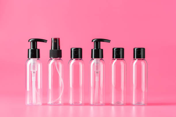 istock Six Clear Plastic Bottles With Black Caps on Pink Background 2161099717