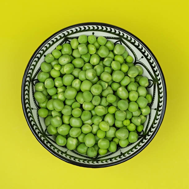 istock dish of raw peas, close-up. 2161100041