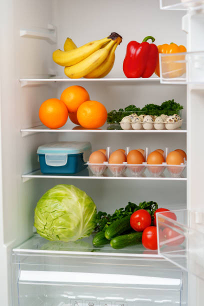 istock Well-Stocked Refrigerator With Fresh Produce, Eggs, and Other Groceries 2161101329