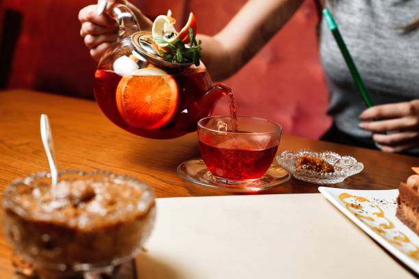 Pouring Citrus Tea In Cafe