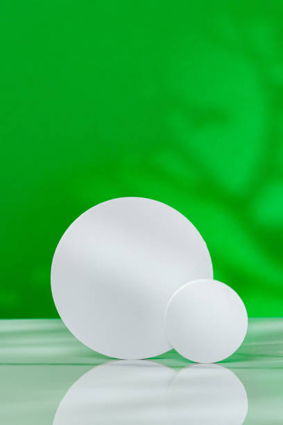 istock Decorative podiums on green background in studio 2161102797