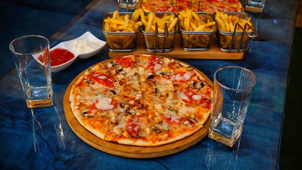 istock Pizza and Fries on a Blue Table 2161103492