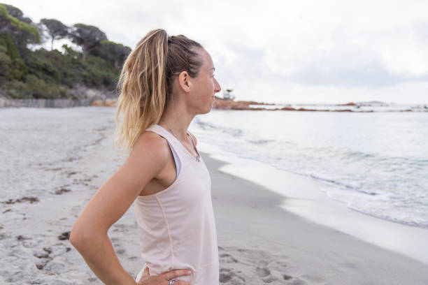 istock Woman Looking at Sea on Beach 2161108467