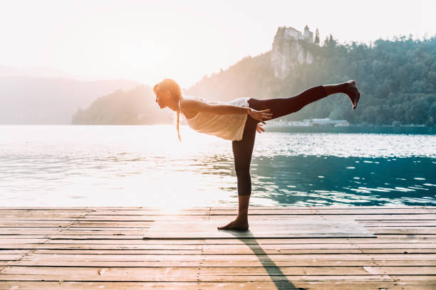 istock Woman doing yoga on lake 2161108750