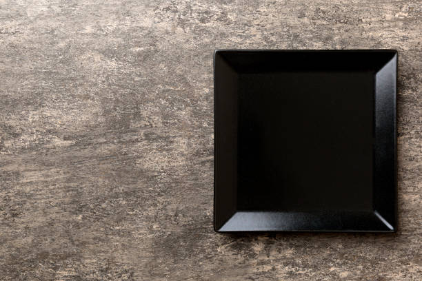 istock Top view of empty square plate on cement background. Empty space for your design 2161110169