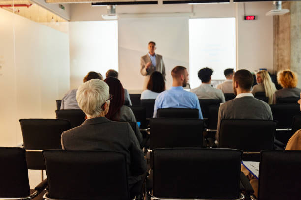 istock Back view of entrepreneurs having a seminar in board room. 2161111506