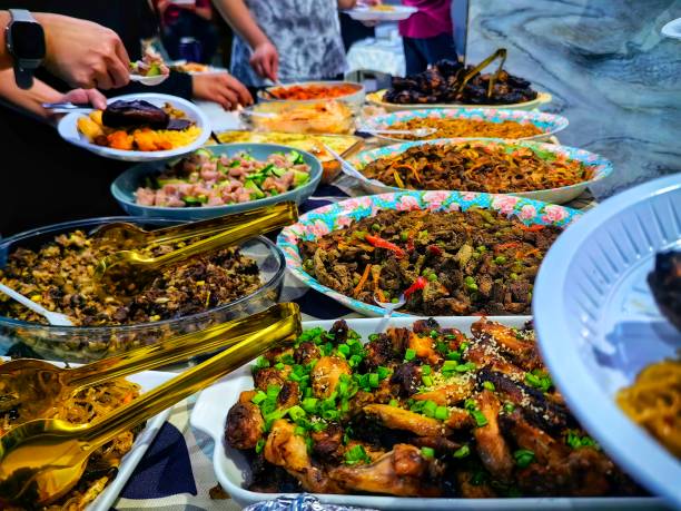 istock Taking foods from various dish which has been prepared on the buffet. 2161113308