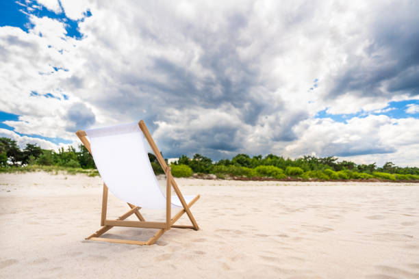 Single outdoor chair on sandy tropical beach during sunset in Sarasota, Florida