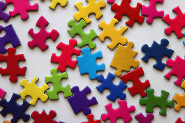 Hands putting together jigsaw puzzle pieces. Teamwork for success. Business cooperation concept. Isolated on white paper background.
