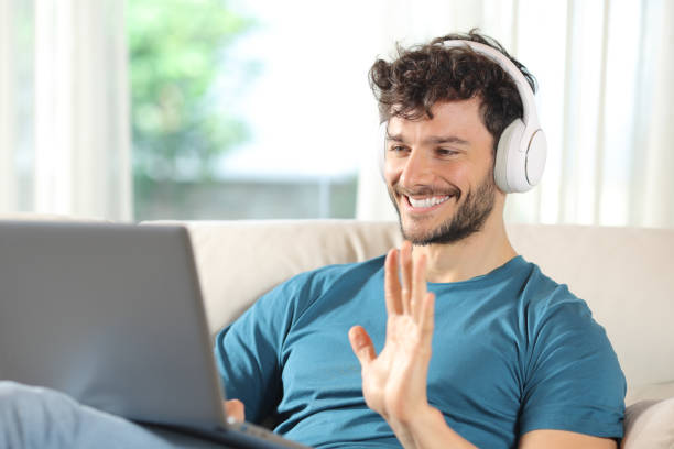 istock Happy man having video call on laptop at home 2161116991
