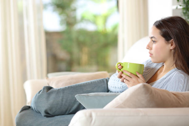 istock Serious pensive woman drinking coffee at home 2161117441