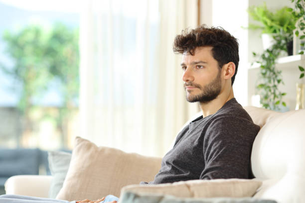 istock Pensive serious man looking away at home 2161117519