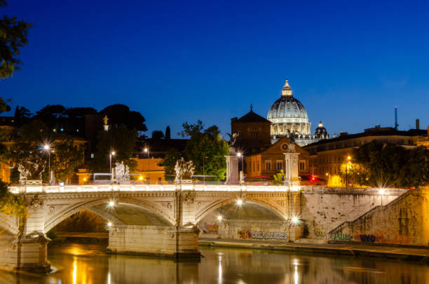 Ponte Sant'Angelo bridge and St Peter's Basilica at dusk, Rome, Italy