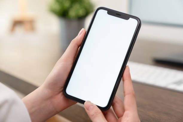 istock Hand holding smartphone mockup of blank screen for graphic display montage. 2161122159