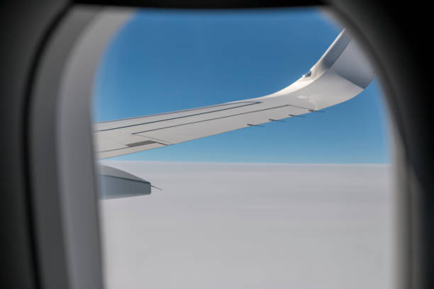 istock Clouds and sky as seen through window of an aircraft. 2161122650