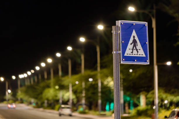 Road with street lights at night. Modern LED street lightning. Darkness. Pedestrian safety at night