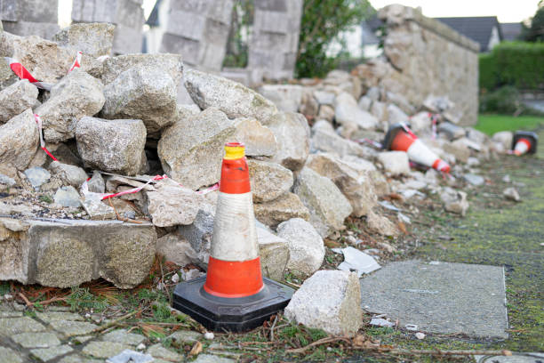 istock Traffic cone against a ruined stone wall after destruction 2161124404
