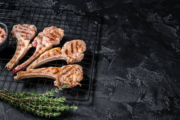 istock Barbecue Grilled lamb meat chops, mutton cutlets. Black background. Top view. Copy space 2161126305