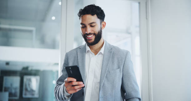 Communication, smile and businessman text with smartphone in office for networking, email and corporate discussion. Male person, mobile message or company social media post for project and consulting