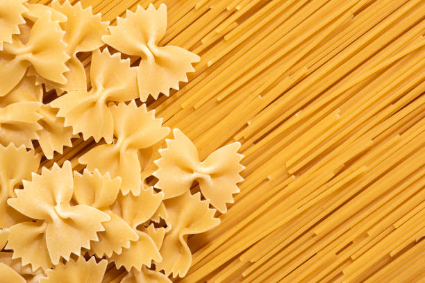 Pasta farfalle and spaghetti, top view. Raw pasta close up, top view.