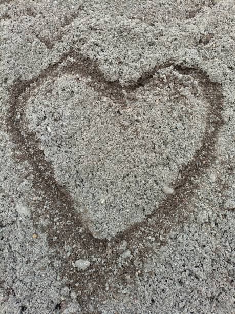 istock Draw a heart shape in the sand 2161135709