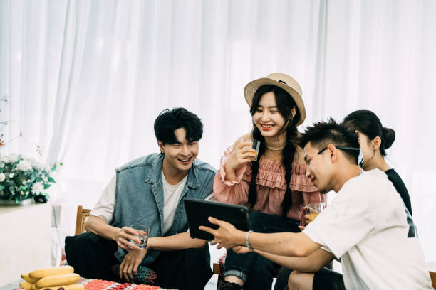 A group of young people looking at a tablet having fun