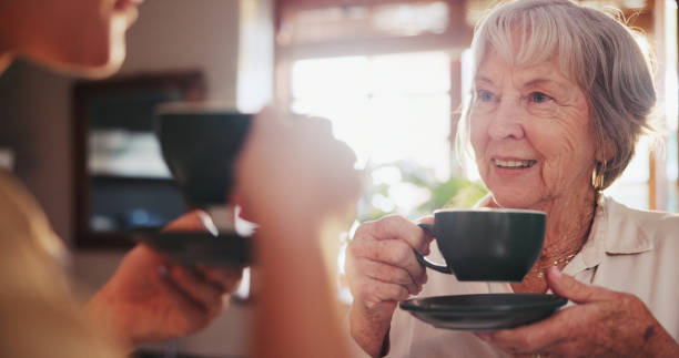 istock Home, discussion and elderly woman with coffee for conversation, bonding and beverage in morning. Happy, senior person and smile with warm drink for retirement, peace and satisfaction in house 2161136069