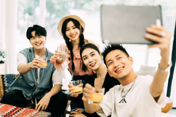 istock Smiling group of Asian friends using digital tablet and have great time 2161136121