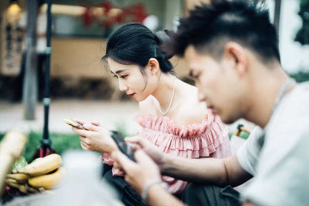 Asian young couple making funny pose for a selfie.