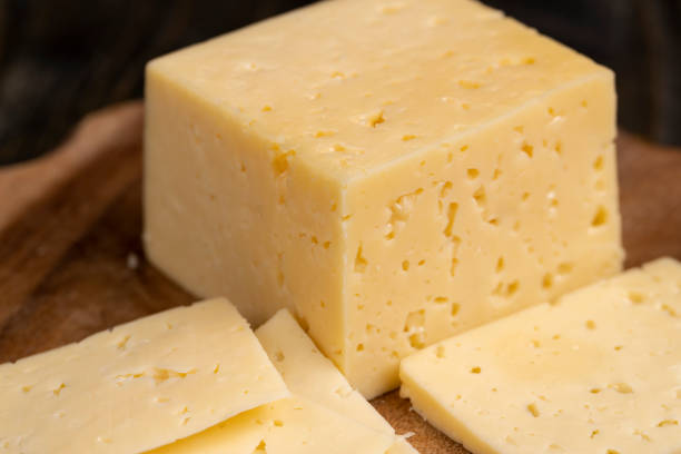 istock a piece of cheese with holes on the table 2161137329