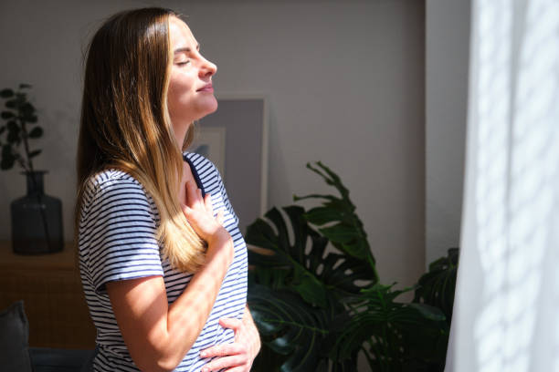 istock Young woman practicing mindfulness breathing exercise at home 2161139804
