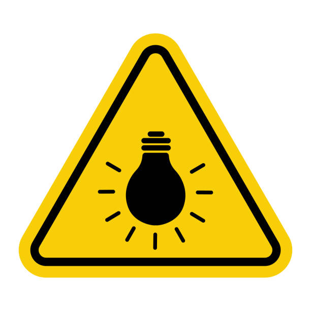 istock Sign bright light bulb. Sign bright light Warning sign about bright light or bright bulb. The light source may be harmful to the eyes. Incandescent lamp. Warning yellow triangular road sign. 2161142193