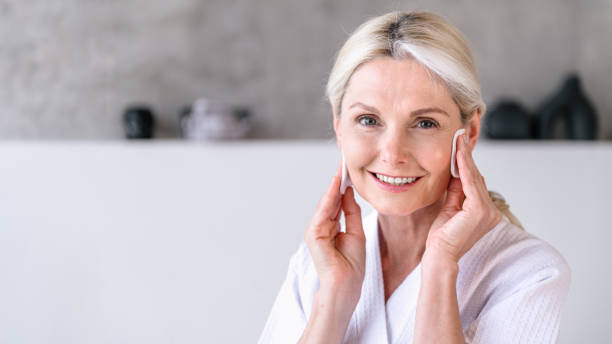 istock Smiling woman looking at camera, doing skincare routine in bathroom 2161143780