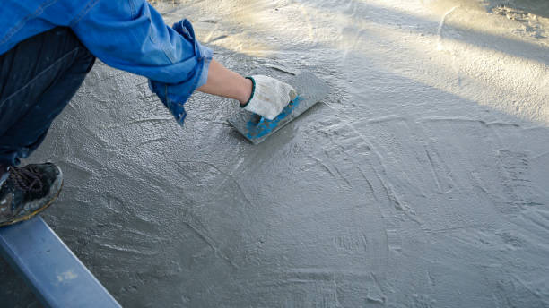 istock Bricklayer laying concrete To create a cement floor inside the house, soft focus 2161144301