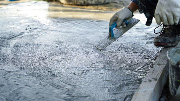 istock Bricklayer laying concrete To create a cement floor inside the house, soft focus 2161144322