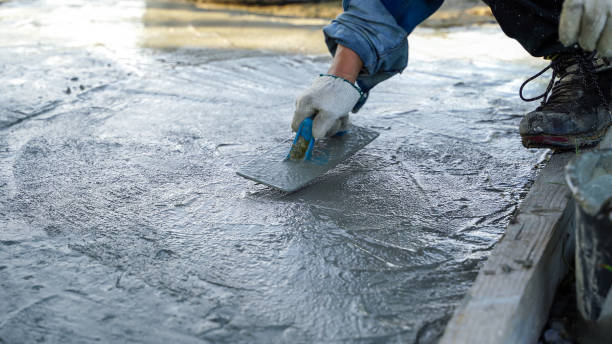 istock Bricklayer laying concrete To create a cement floor inside the house, soft focus 2161144361