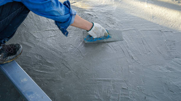 istock Bricklayer laying concrete To create a cement floor inside the house, soft focus 2161144445