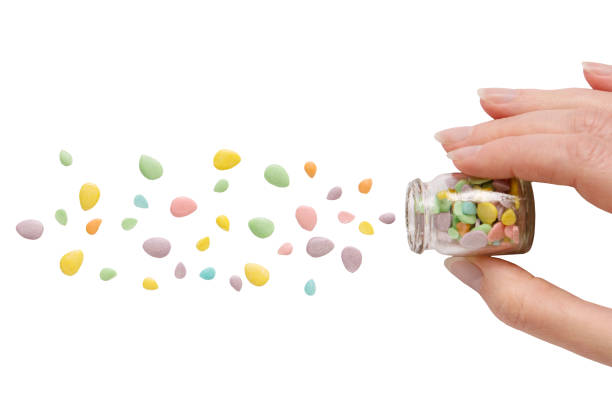 istock Sweet sugar multi-colored sprinkles pile, scattered drops, hand, isolated on white background, top view 2161144813