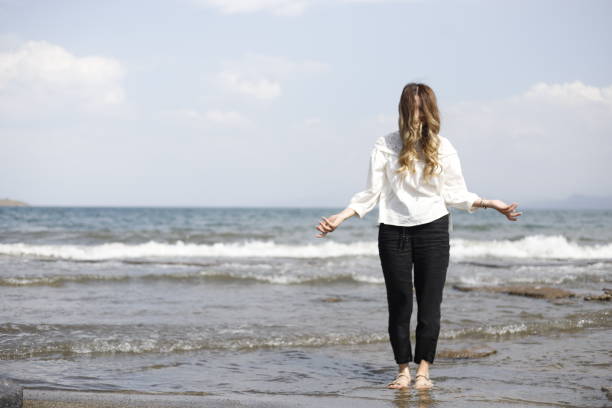 istock blonde haired woman spending time on the beach 2161145363
