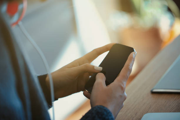 istock Young woman browsing on smartphone in cozy kitchen 2161146068