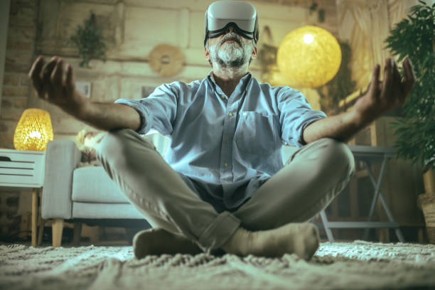 Senior man using virtual reality headset during meditation and yoga