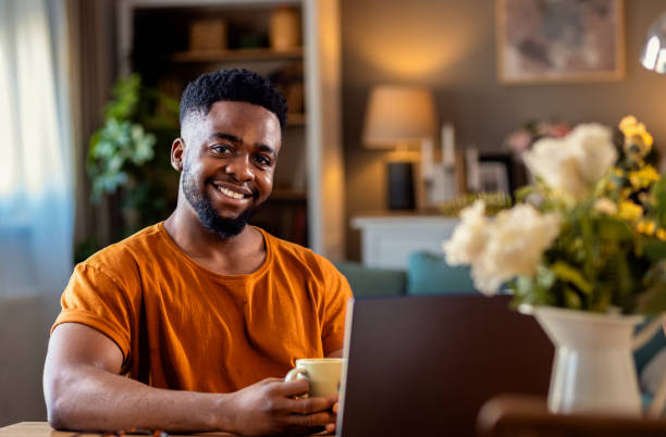 istock Young African American man sitting at home using laptop for video call. 2161151979