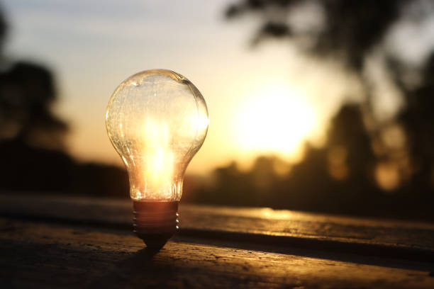 istock energy and business concept image. Creative idea and innovation. light bulb metaphor in front of the sun 2161152483