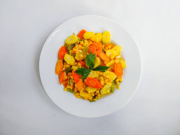 Tumis Wortel Dan Jagung Muda or Carrot and Baby Corn Stir Fry, served on the bowl. Isolated on white background